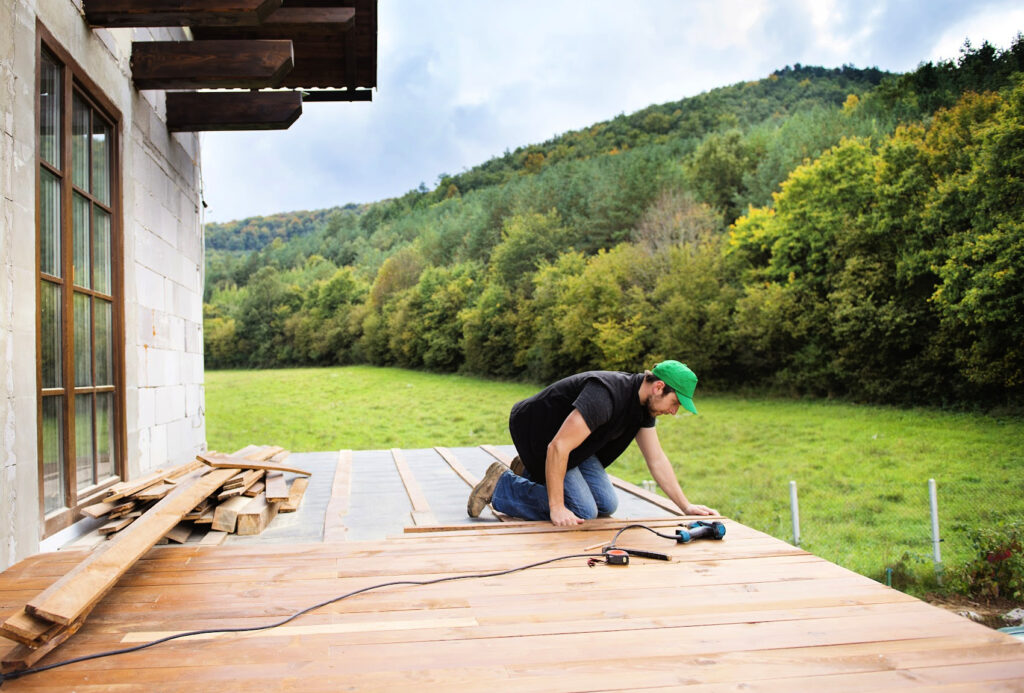 Construction worker installing deck flooring